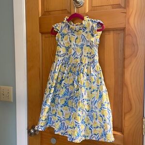 Little girl’s dress yellow, blue, white and golden with matching headband.
